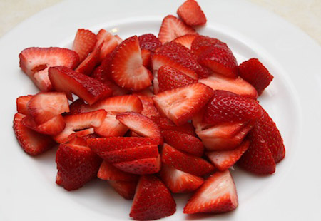 strawberries, sliced, cutting board