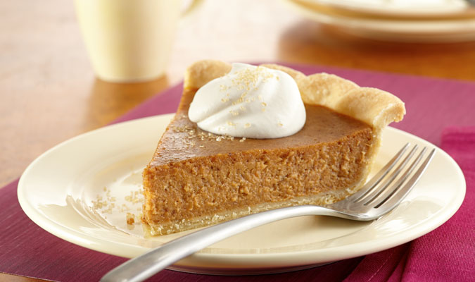 slice sweet potato pie with whipped cream on top